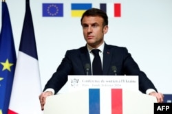French President Emmanuel Macron speaks during a press conference at the end of the international conference aimed at strengthening Western support for Ukraine, at the Elysee presidential palace in Paris, on February 26.