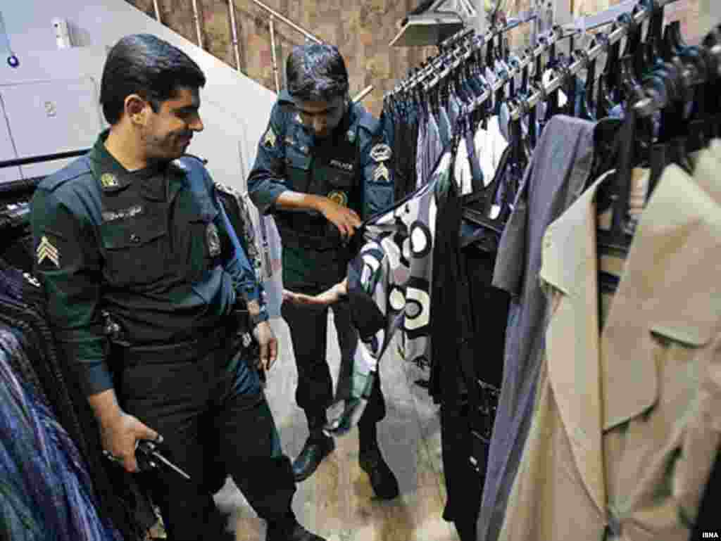 Iranian police launch a new crackdown on un-Islamic dress. - Police inspecting clothes in a store in Tehran in a new crackdown aimed at forcing women to adhere to Islamic codes more strictly, 14 June 2008.