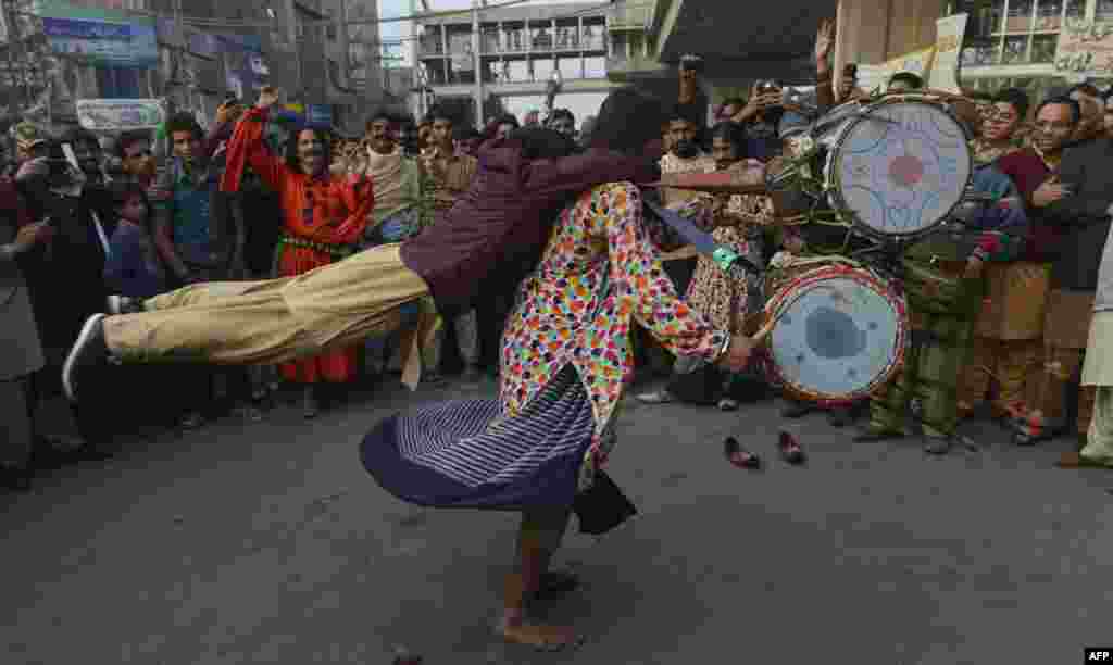 Pakistani Muslim devotees perform at the shrine of Sufi Saint Syed Ali bin Osman Al-Hajvery, popularly known as Data Ganj Bakhsh, during the annual&nbsp;&quot;Urs&quot; religious festival in Lahore on December 12. (AFP/Arif Ali)