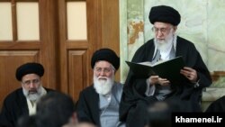 FILE photo - Iran's Supreme Leader Ali Khamenei with his close supporter Ahmad Alamolhoda (C).