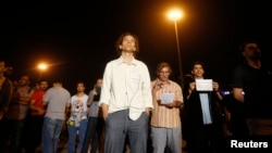 Erdem Gunduz (center) stands in silent protest on Taksim Square in Istanbul on June 18, staring up at an image of modern Turkey's founder, Kemal Ataturk.