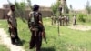 Afghan militias and policemen gather during a battle with Taliban militants in the Chardara district of Kunduz Province last month.