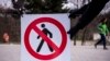 Kosovo - Workers place a sign at the entrance of a park in Pristina during coronavirus pandemia on March 22 2020.