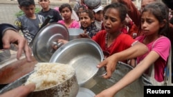 Палестинцы собираются, чтобы получить еду, Нусейрат, сектор Газа, 8 апреля 2025 года