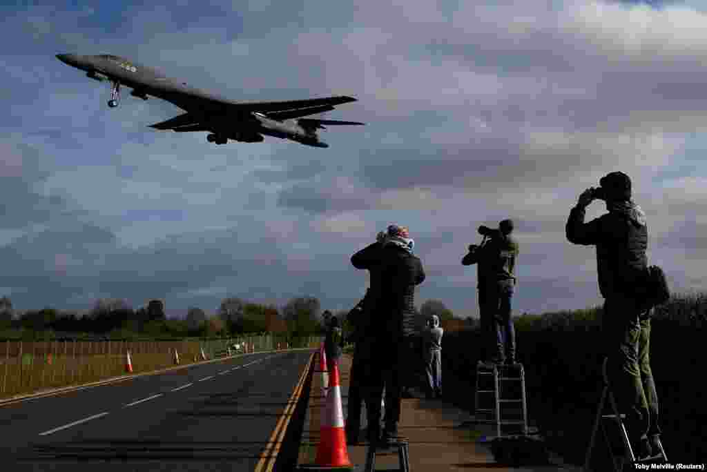 Photographers track a US bomber jet as it prepares to land at the Fairford air base in Gloucestershire, United Kingdom, on March 17.London has granted the US permission to use the Fairford base, and air fields at Diego Garcia, in the Indian Ocean, for ongoing strikes on Iran.