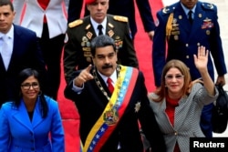 Николас Мадуро, его жена Силия Флорес (справа) и председатель Национального учредительного собрания Делси Родригес (слева, ее нынешний режим в Каракасе прочит в новые лидеры страны) прибывают на специальное заседание Национального учредительного собрания. 24 мая 2018 года