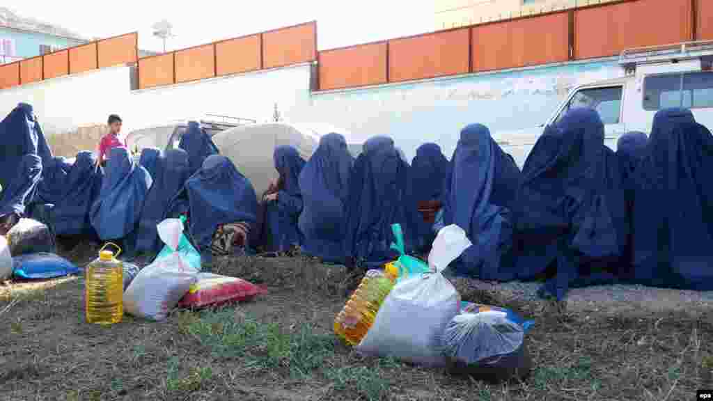 Burqa-clad women from Kunduz wait to receive aid in neighboring Badakhshan Province.