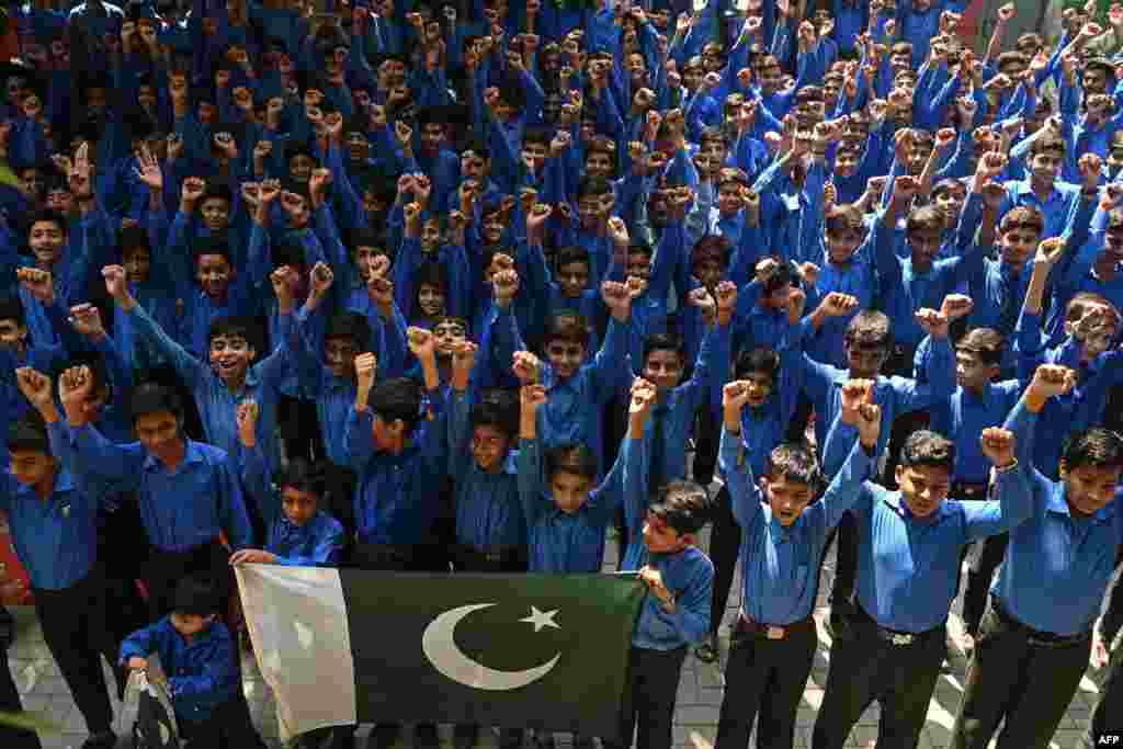 Students shout slogans as they express solidarity with Pakistan's armed forces during a school assembly in Lahore on May 12 after schools reopened following a cease-fire between Islamabad and New Delhi amid hostilities over the disputed region of Kashmir.