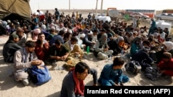 Afghan refugees gather at the Iran-Afghanistan border in August 2021.