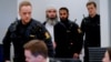Zaniar Matapour (center) attends court in Oslo earlier this year. 