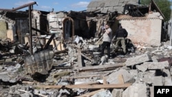 Local residents examine a private house destroyed by a missile attack in the village of Krasylivka in the Kyiv region on May 8.