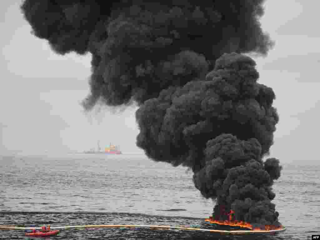 A controlled oil fire burns in the Gulf of Mexico, near the coast of Louisiana, where thousands of gallons of oil have leaked from the BP-operated Deepwater Horizon rig, causing massive environmental damage. Photo by Justin E. Stumberg for U.S. Department of Defense/AFP 