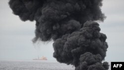 Oil burns during a controlled fire in the Gulf of Mexico 