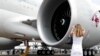 A visitor photographs the General Electric GE90 engine at the Farnborough Air Show in the U.K. in July 2018.