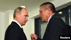 Russian President Vladimir Putin (left) listens to Economy Minister Aleksei Ulyukayev ahead of a meeting with Venezuelan President Nicolas Maduro in Istanbul, Turkey, on October 10.