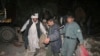 Afghan police and locals carry a wounded man from the site of a suicide attack in Trinkot city, southern Uruzgan province. (file photo) 