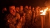 Ukrainian soldiers of the 3rd Assault Brigade take part in a memorial for their fallen comrades during the Winter Solstice in the Kharkiv region on December 22.