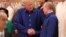 U.S. President Donald Trump (left) shakes hands with Russia's President Vladimir Putin as they pose for a group photo ahead of the APEC summit leaders' dinner in Danang, Vietnam, on November 10.