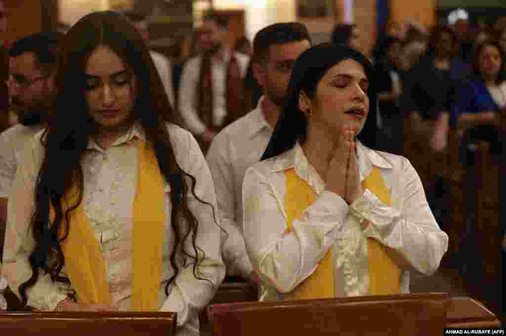 Christian worshippers pray for an end to the war in the Middle East during a "world peace" mass in a church in Baghdad, Iraq, on April 16.