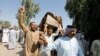 Mourners carry a coffin containing a victim of rocket attacks in the Abu Ghraib district on the outskirts of Baghdad on September 29.