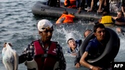 Migrants arrive on the shores of the Greek island of Lesbos after crossing the Aegean Sea from Turkey on a dinghy on September 9.