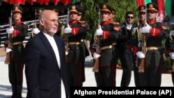 Afghan President Ashraf Ghani inspects the honor guard during Independence Day celebrations at Defense Ministry in Kabul on August 19.