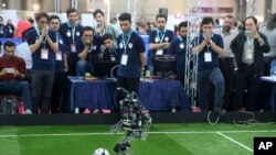 A humanoid robot of Iranian students from Amir Kabir university plays in a soccer match during the international robotics competition, RoboCup Iran Open 2016, in Tehran, Iran, Wednesday, April 6, 2016. The event, organized by Iranian RoboCup Regional Comm