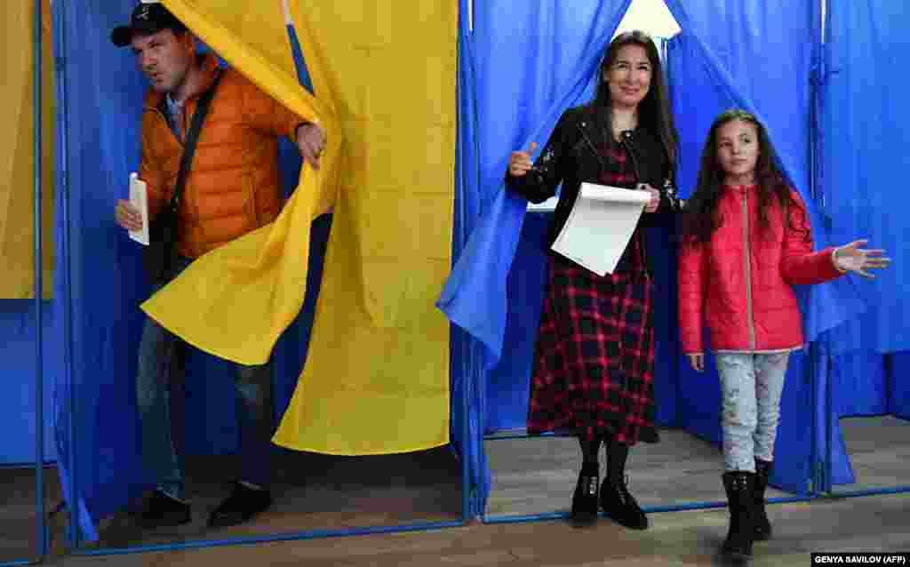 Люди виходять з кабін для голосування на виборчій дільниці під час президентських виборів у Києві