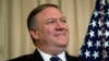 U.S. -- U.S. Secretary of State Mike Pompeo listens as U.S. President speaks during a ceremonial swearing in at the State Department, in Washington, May 2, 2018 