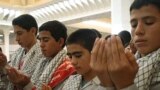 Iran -- Basij activists pray in Tehran, Jul2006