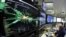 A graphic shows a collision at full power at the Compact Muon Solenoid experience control room of the Large Hadron Collider at the European Organization for Nuclear Research (CERN) in Meyrin.