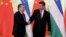 Uzbek President Shavkat Mirziyoev (left) meets Chinese President Xi Jinping in Beijing on April 25.