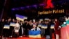 Guests of the Berlin Film Festival hold up signs in support of Ukraine on the anniversary of Russia's unprovoked invasion on February 24. 