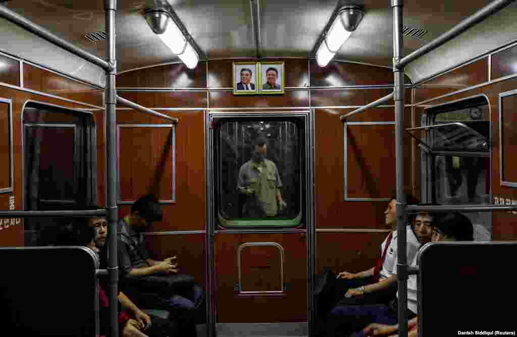 Portraits of the late North Korean leaders Kim Il Sung and Kim Jong Il are seen on a train as it leaves a subway station in Pyongyang, North Korea, on September 11, 2018.