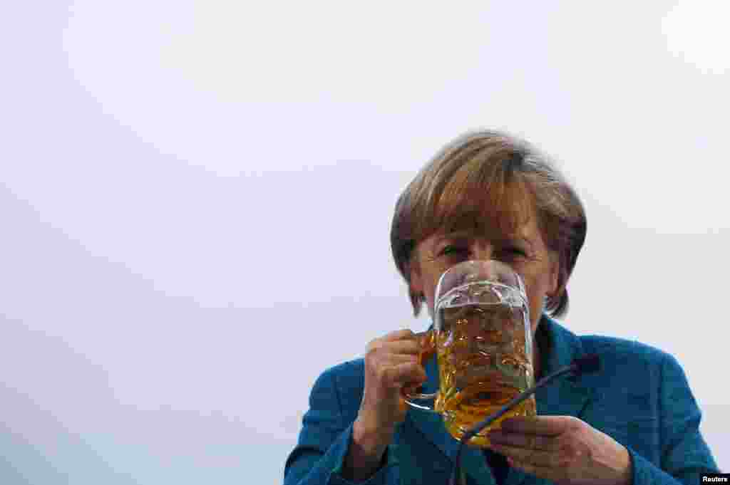 Angela Merkel drinks a beer after her speech in a beer tent in Munich in May 2013.