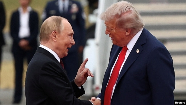 Путін тисне руку Трампу, пройшовши від трапа літака по червоній доріжці. Летовище у Анкоріджі. Аляска, США. 15 серпня 2025 року
