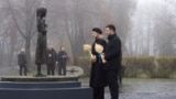 Ukrainian President Volodymyr Zelenskyy and first lady Olena Zelenska visit a monument to Holodomor victims in Kyiv on November 22. 