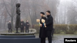 Ukrainian President Volodymyr Zelenskyy and first lady Olena Zelenska visit a monument to Holodomor victims in Kyiv on November 22. 