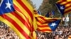 Spain -- People react as they watch on giant screens a plenary session outside the Catalan regional parliament in Barcelona, Spain, October 27, 2017