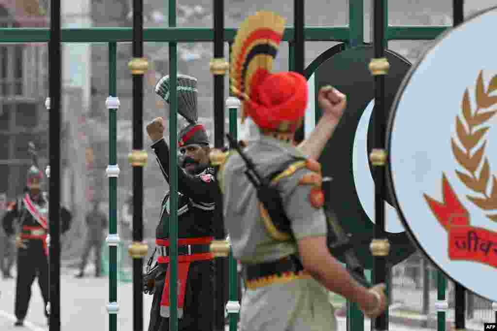 Pakistani Rangers (left) and Indian Border Security Force personnel perform the Attar-Wagah border ceremony at the frontier between the two countries on the outskirts of Amritsar.