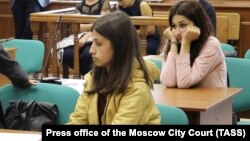 Two of the three sisters accused of killing their father, Angelina Khachaturyan (front) and Krestina Khachaturyan (back), at a court hearing in Moscow. (file photo)