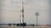 An Iranian rocket carrying a satellite is prepared for launch from an undisclosed site believed to be in the Semnan province, April 22, 2020