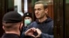 Russian opposition leader Aleksei Navalny shows a heart symbol during a court hearing in Moscow on February 2.