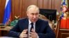 Russian President Vladimir Putin speaks at the Kremlin in Moscow on June 5. The Kremlin said that audio messages released earlier in the day purporting to be by Putin about imposing martial law in three regions were "utterly fake." 