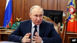 Russian President Vladimir Putin speaks at the Kremlin in Moscow on June 5. The Kremlin said that audio messages released earlier in the day purporting to be by Putin about imposing martial law in three regions were "utterly fake." 