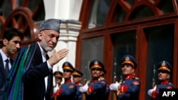 Outgoing Afghan President Hamid Karzai arrives for Ashraf Ghani's swearing in ceremony as the country's new president at the Presidential Palace in Kabul on September 29, 2014.