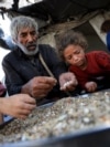 Gaza - Displaced Palestinians who have not received humanitarian aid gather as they survive on leftover food, amid a hunger crisis, in Gaza, July 28, 2025. 