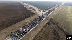 Students march through Indija, in northern Serbia, on their way to Novi Sad, where a concrete canopy collapsed killing 15 people almost three months ago.