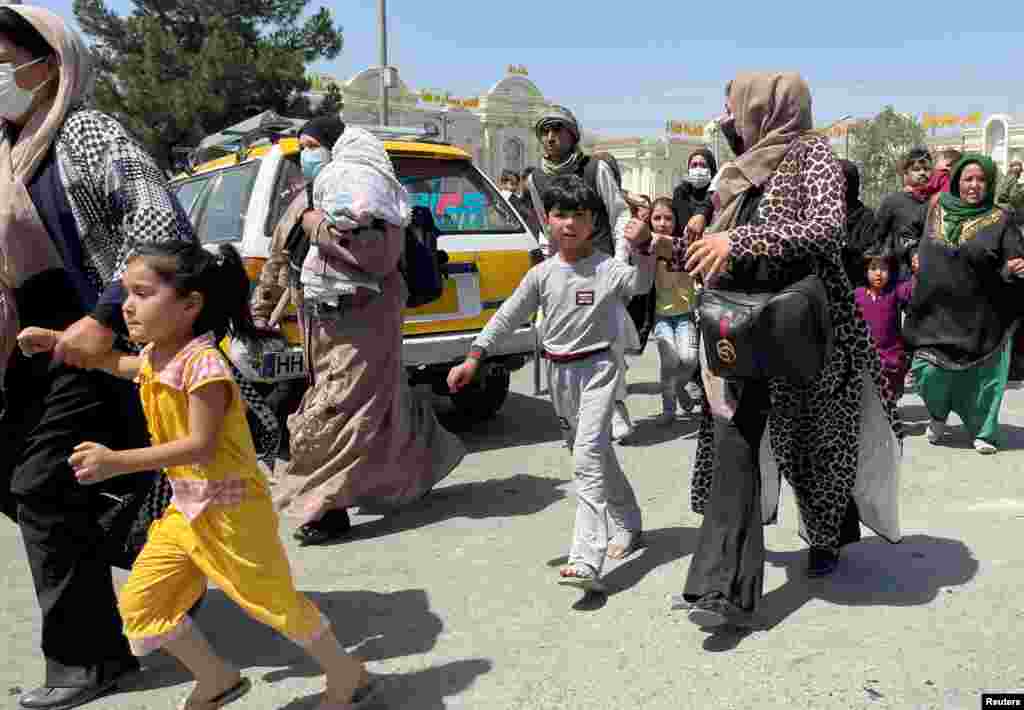 Women with their children try to get inside Hamid Karzai International Airport in Kabul, Afghanistan, on August 16.&nbsp;