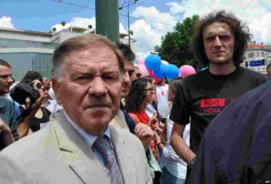 Sarajevo Mayor Ivo Komsic (left) stands with protesters gathering in front of the parliament building in Sarajevo.